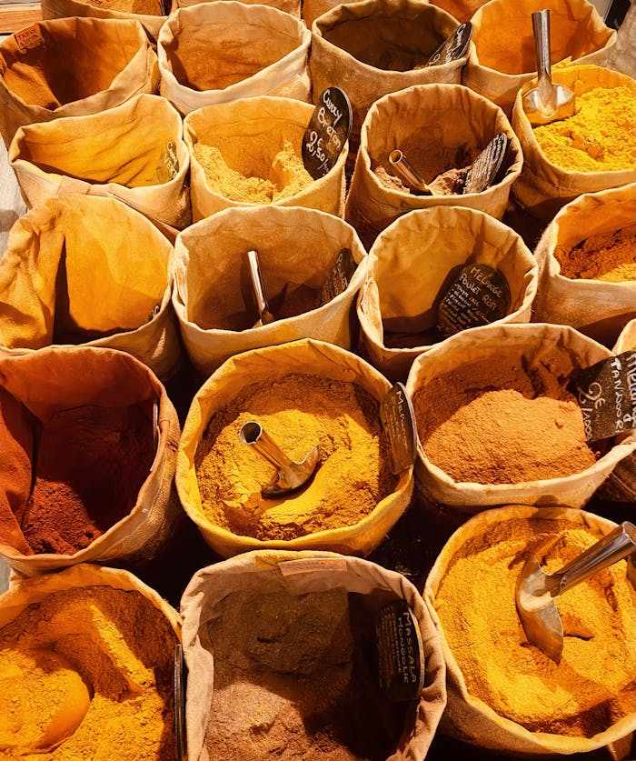 A vibrant display of spices in sacks at a market in Marseille, France.
